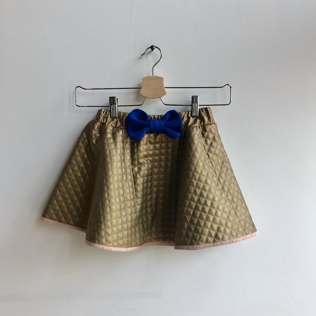 Bang Bang Copenhagen gold quilted skirt with blue bow at Manifesto Woman